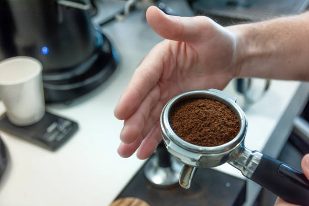 istock Barista presses ground coffee in the spoon 1161760469