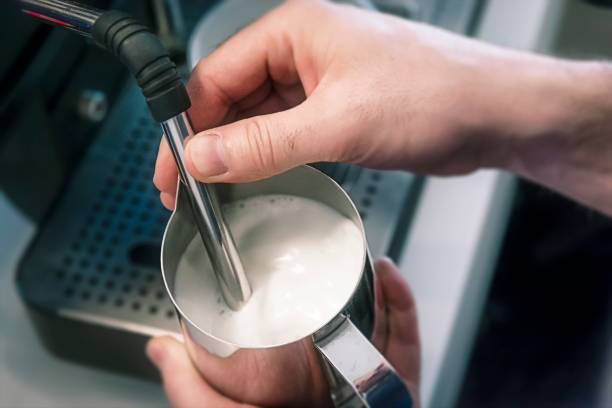 istock Barista steaming milk in coffee shop 1161760474