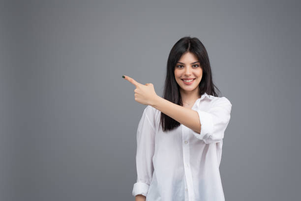 istock Attractive young brunette woman isolated on grey background 1161760499