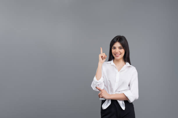 istock Attractive young brunette woman isolated on grey background 1161760508