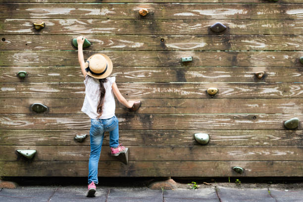 istock Girl climbing a wall 1161760641