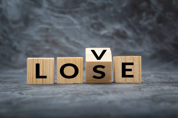 Wooden cube block with word LOVE change to LOSE stock photo