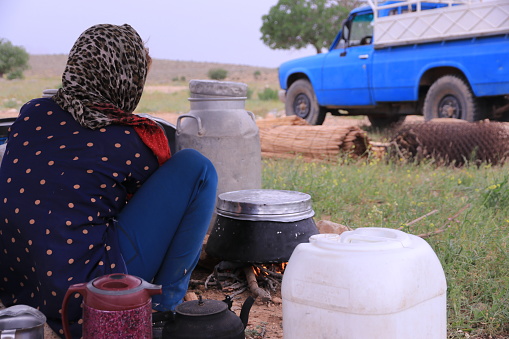 Shiraz, May 05/2019; Iranian Nomadic women cooking dishes outside .