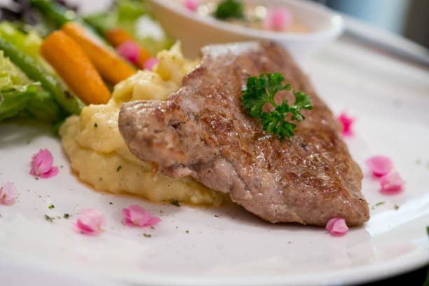 istock Pork grill steak set has baked potato with butter. focus select 1161762820