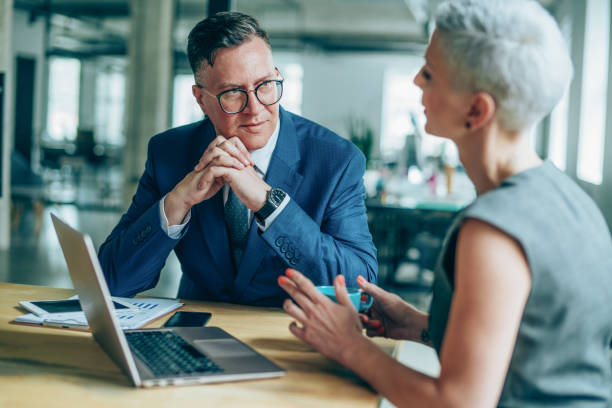 istock Business persons talking in conference room 1161765544