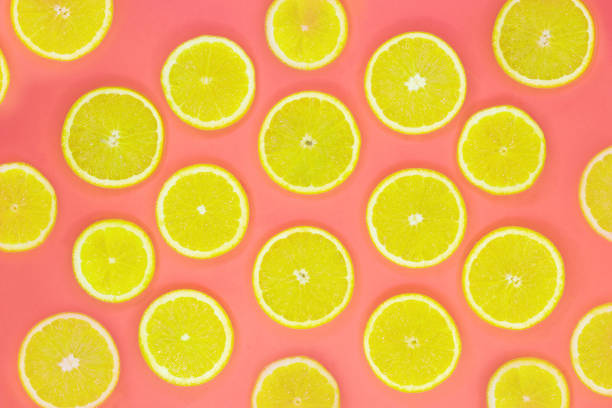istock Colorful fruit pattern of fresh orange slices on coral background 1161768136