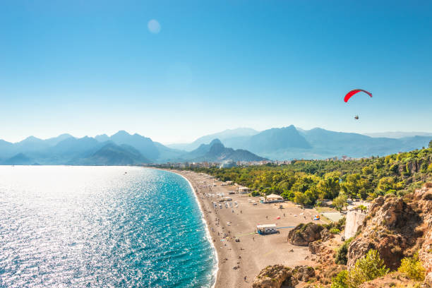 Panoramic bird view of Antalya and Mediterranean seacoast and beach with a paraglider, Antalya, Turkey Panoramic bird view of Antalya and Mediterranean seacoast and beach with a paraglider, Antalya, Turkey, Autumn turkey stock pictures, royalty-free photos & images