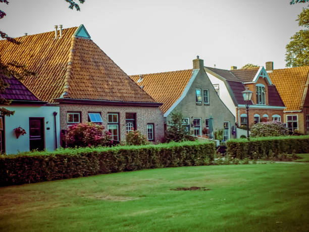 Modern row houses with brown bricks and red roof tiles in Netherlands