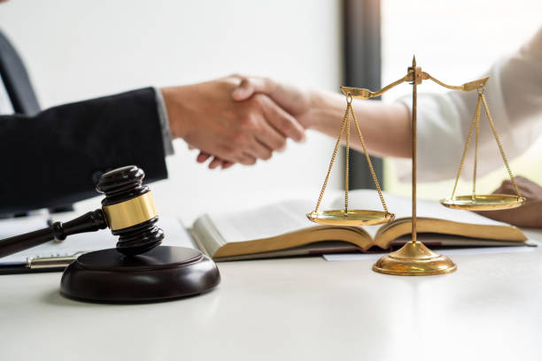 istock Close-Up Of Lawyers Shaking Hands 1161773839