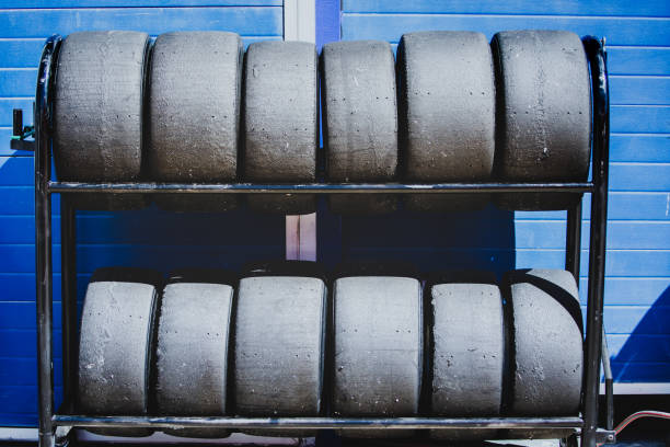 Image of racing tires piled up with a blue background