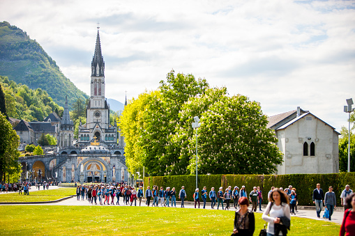 Lourdes, France - May 01, 2019:  Worshippers at the Sanctuary of Our Lady of Lourdes, France