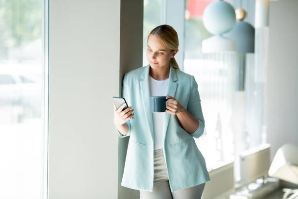 istock Young elegant female manager reading notification in smartphone 1161779876