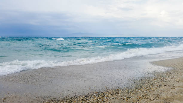 Tropical seascape waves crash over the beach. Sky and sea