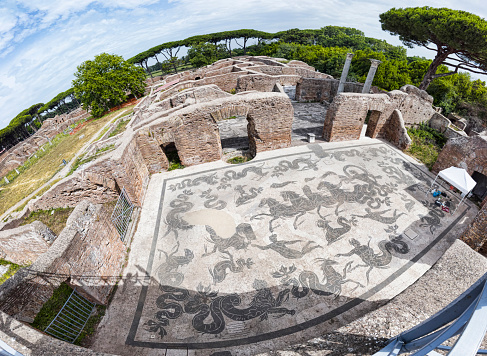 Panoramic view of the thermal baths of Neptune in the archaeological excavations of Ostia Antica with the famous mosaic depicting the Triumph of Neptune with the God of the sea above a carriage drawn by seahorses is surrounded by dolphins, Nereids and sea monsters