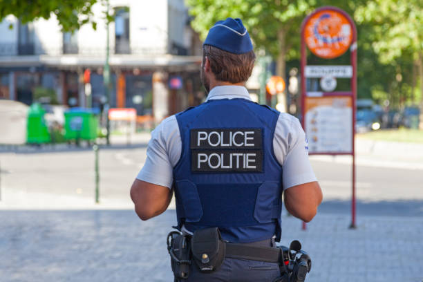 Belgian policeman in bulletproof vest Brussels, Belgium - July 03 2019: Policeman in bulletproof vest patrolling the street. capital region stock pictures, royalty-free photos & images