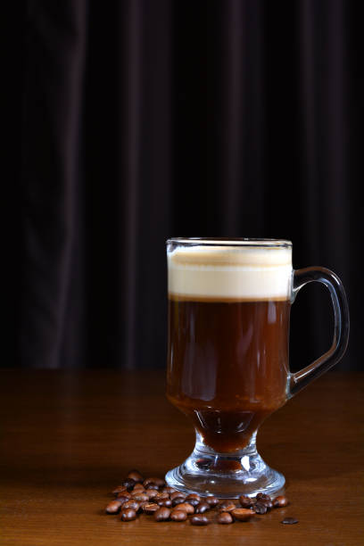 istock Irish coffee in a glass cup on a wooden table. Dark background. 1161784368