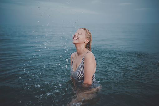 portrait of woman having fun in sea