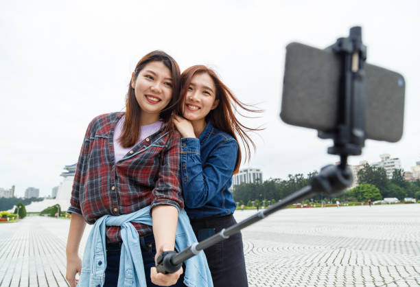 istock Asian girls taking selfie with a selfie stick 1161786368