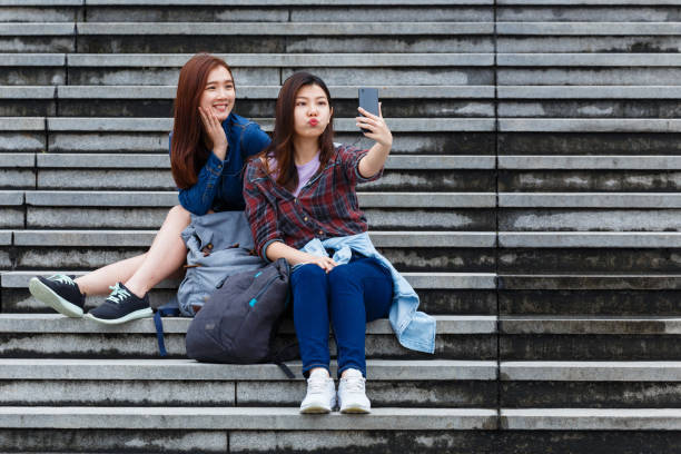 istock Asian girls taking selfie on staircase 1161786375