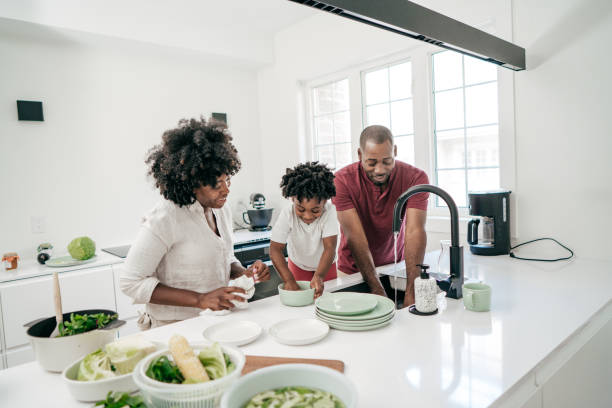 istock Dad, Mom and daughter in the kitchen 1161787778