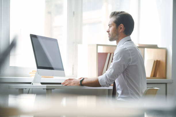 istock Serious broker concentrating on looking through online financial data 1161787940