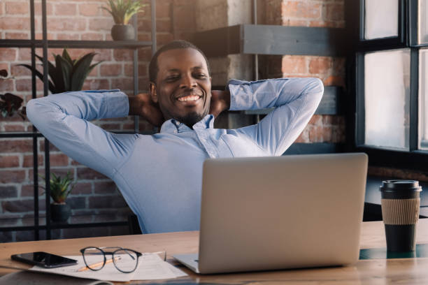 istock African businessman resting during his break from work, head on hands and spreading elbows 1161788013