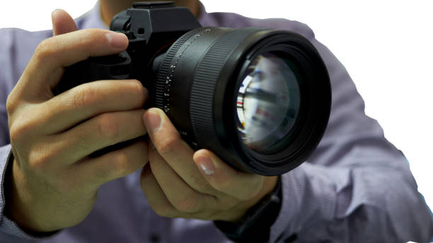 istock Hands hold camera and lens for take photo on isolated white background 1161789255