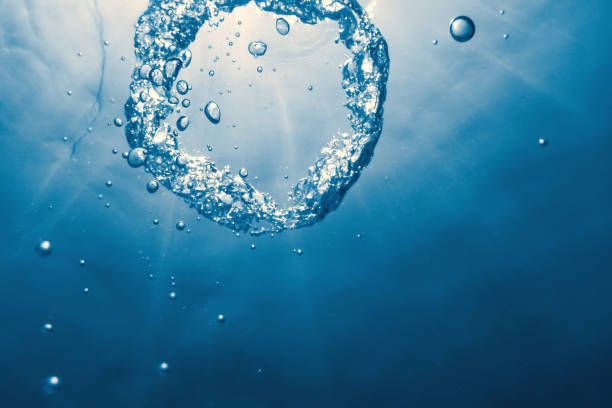 istock Bubble ring Underwater ascends towards the sun. 1161790247
