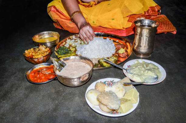 istock Indian woman eating vegetarian thali by her hand 1161791441
