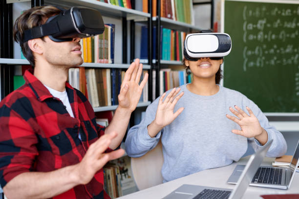 istock Young astonished man and woman in vr headsets having virtual experience 1161792620