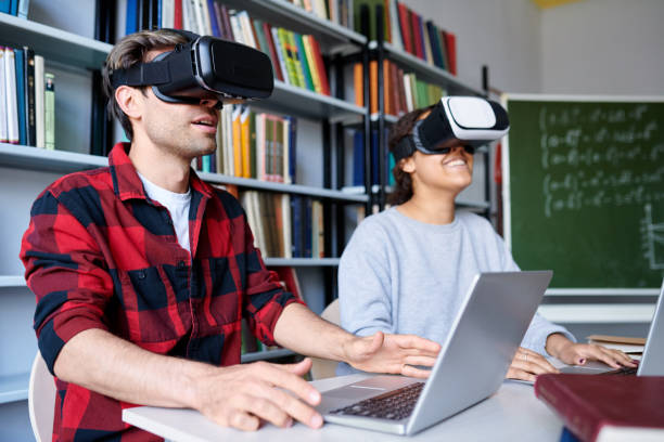 istock Two young college students in vr headsets watching virtual presentation 1161792666