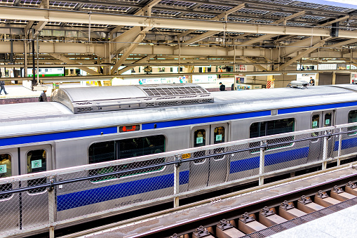 Tokyo, Japan - March 30, 2019: Inside of Shinjuku train JR rail railway station with local train to Shinagawa by platform