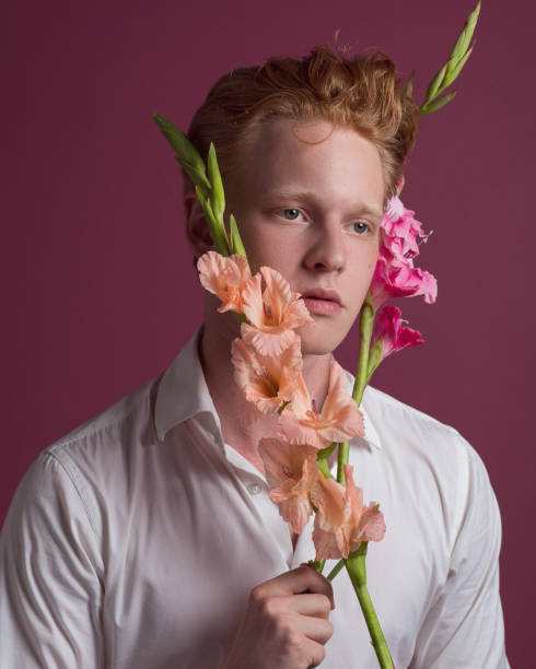 istock Young redhead man with flowers 1161799115