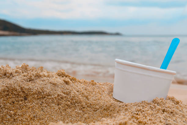 istock Paper cup for ice cream on the sandy beach with sea background 1161799859