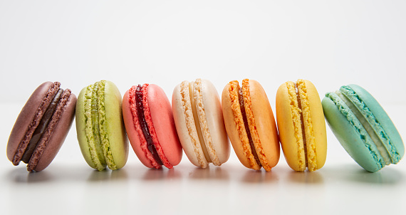 Colorful macaroons on white background.