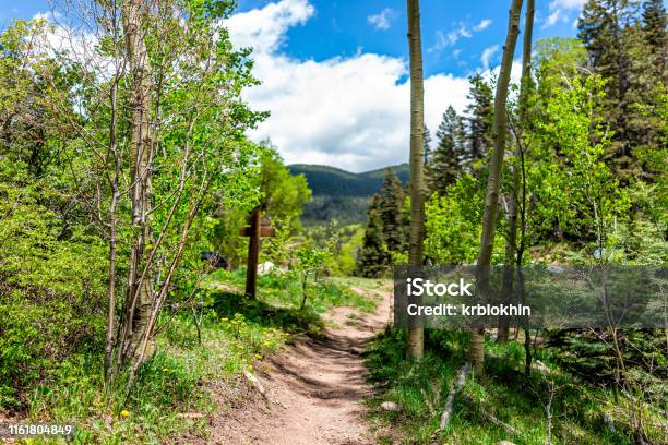 Santa Fe National Forest Park Trail With Sign Entrance At Trailhead Sangre De Cristo Mountains And Green Aspen Trees By Parking Lot Stock Photo - Download Image Now