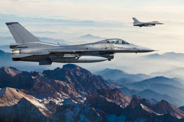 istock Figher jets flying over the mountains 1161808545