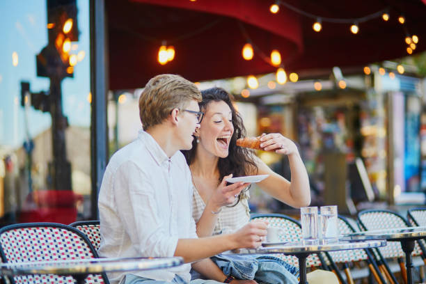 Happy romantic couple in Paris, drinking coffee