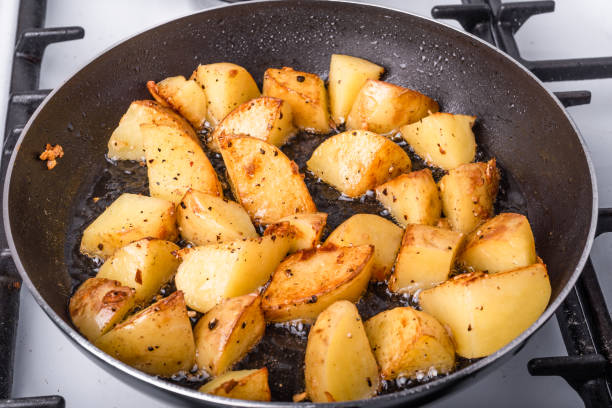 istock Cooking a rustic breakfast - large pieces of potatoes are fried in a pan 1161811961