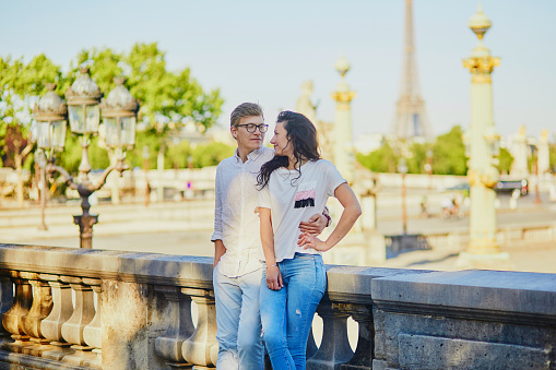 Happy romantic couple in Paris in Tuileries garden. Tourists spending their vacation in France