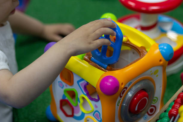 istock Little girl playing with toy cube in game room 1161812698
