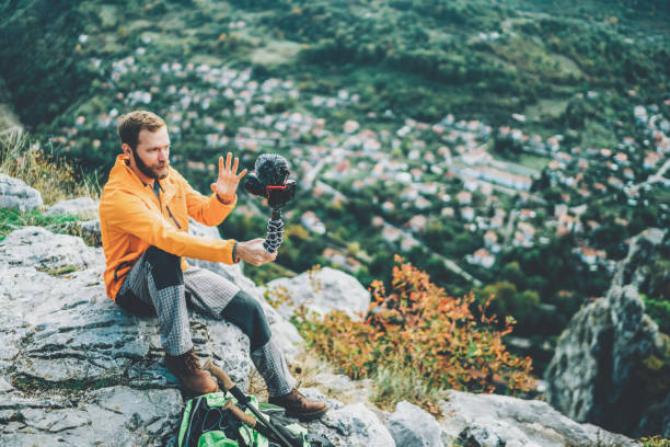 istock Influencer tourist hiking and vlogging on the mountain top 1161814092