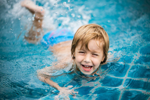 istock Cute little boy swimming at the pool 1161816592