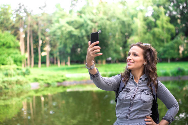 istock Beautiful young millennial woman taking selfie photo 1161816607