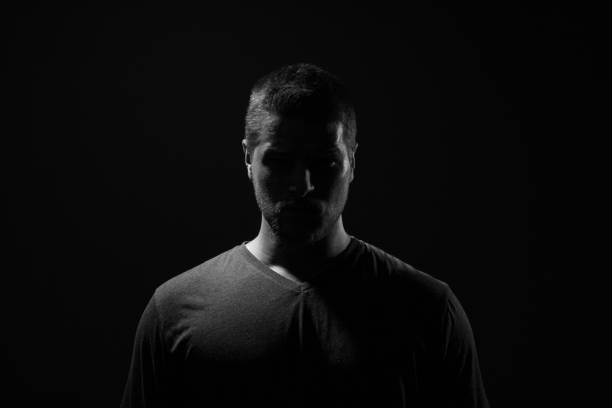 istock Dangerous Man face in the darkness 1161819366