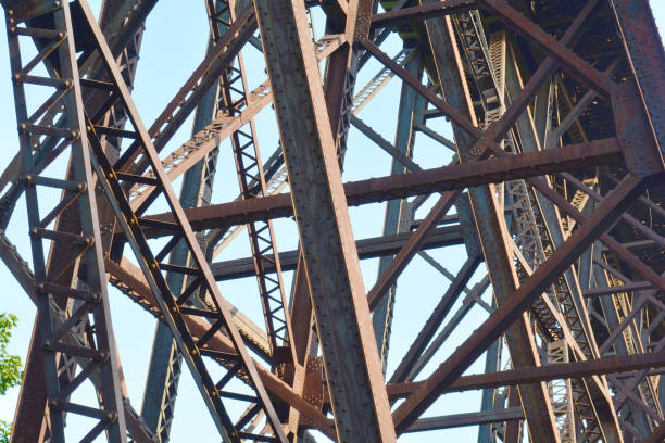 istock Rusty, brown metal rail road bridge from below. Railway steel bridge structure. 1161824326