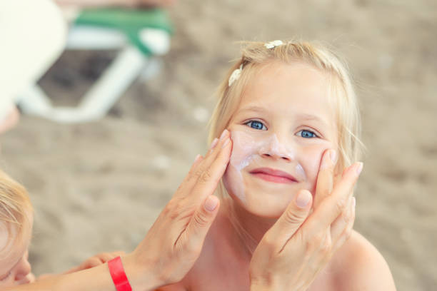 istock Mother applying sunscreen protection creme on cute little daughter face. Mom using sunblocking lotion to protect kid girl from sun during summer sea vacation. Children healthcare at travel time 1161825271