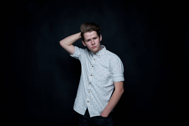 istock Young handsome man standing in front of black background 1161826563