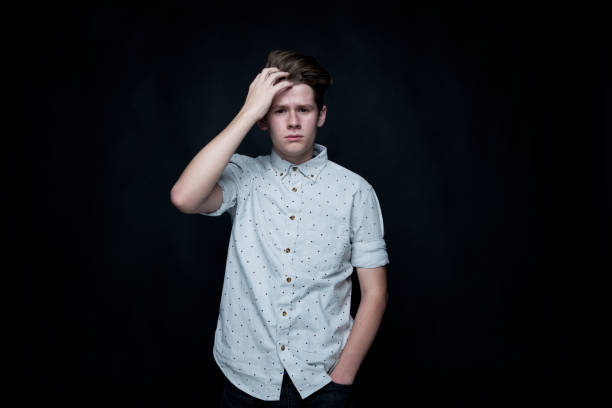 istock Young handsome man standing in front of black background 1161826668