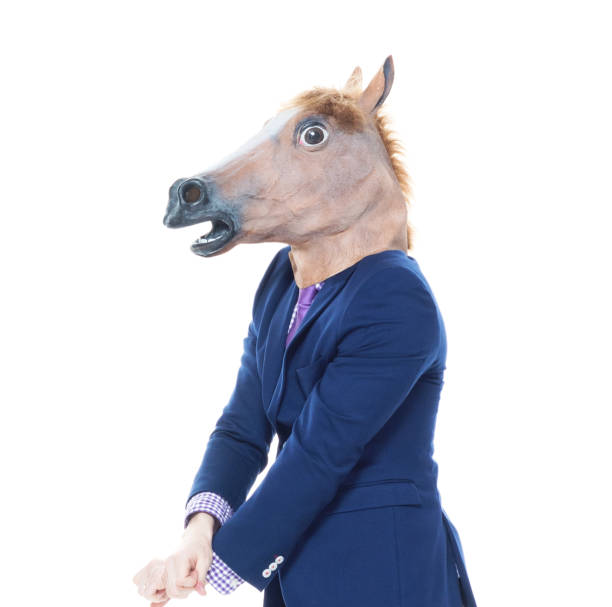 istock Businessman with horse mask is dancing 1161826767